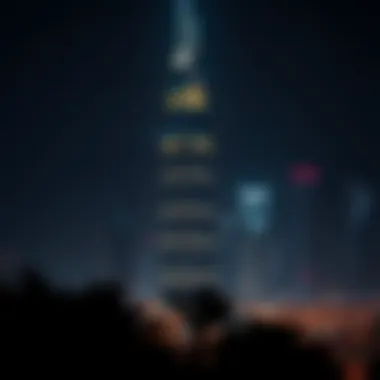 Night view of Nation Towers illuminated against the Dubai skyline